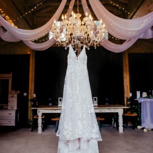 black barn dress hanging on chandilier ds photography
